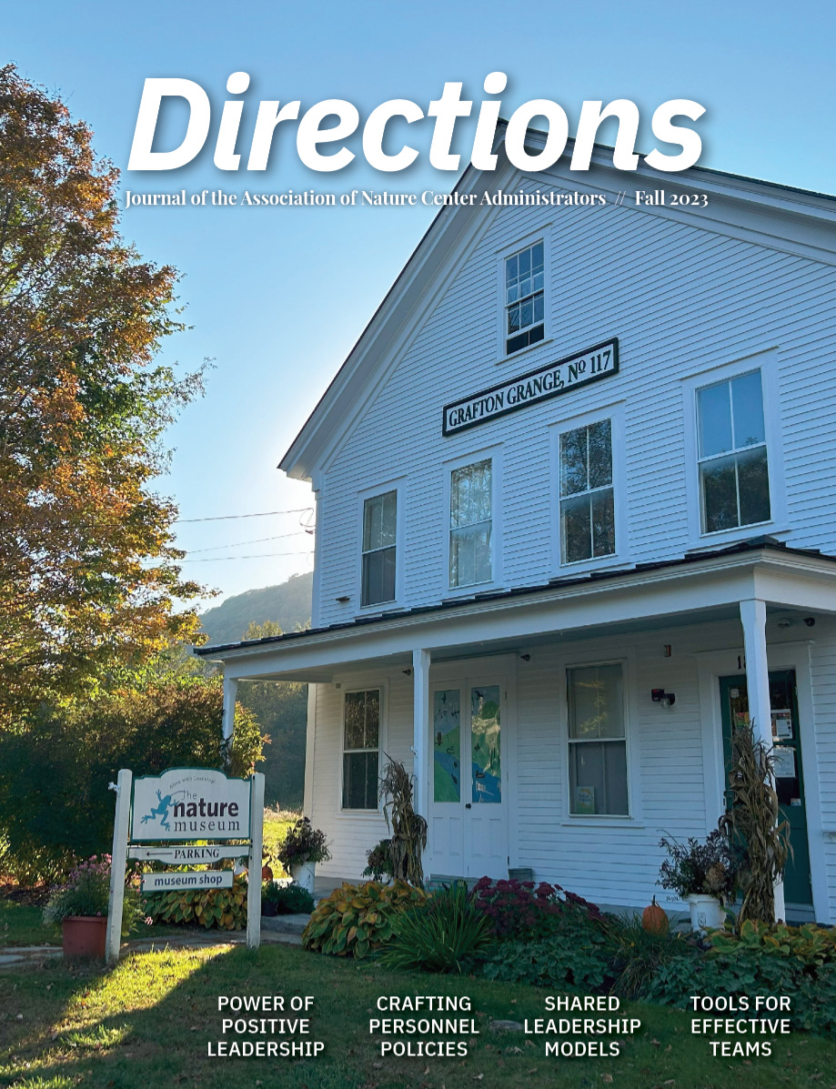 The cover of Directions. A white A-frame building fills most of the page. Sunlight shines behind the building and an autumnal tree stands to the left.